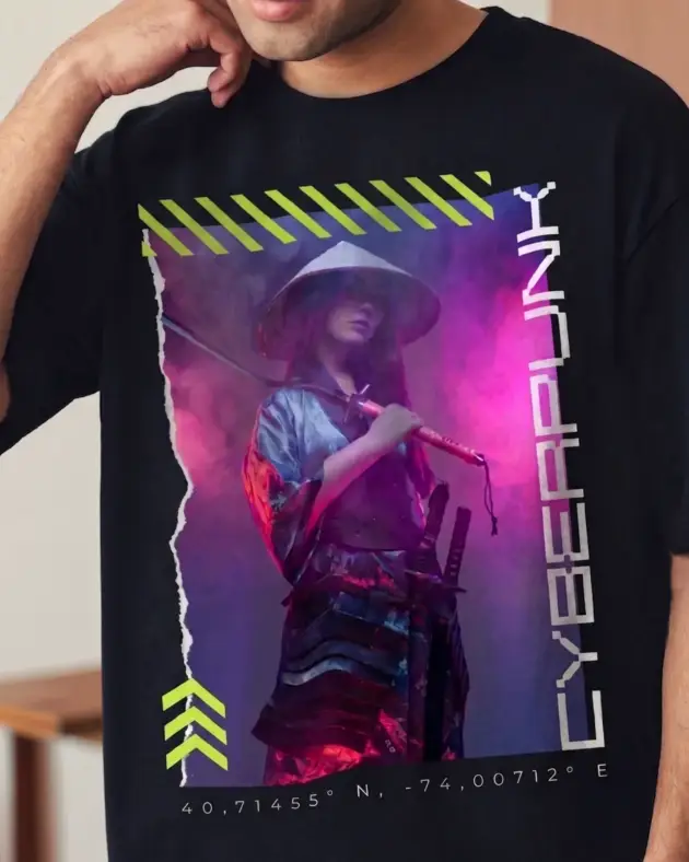 Close-up of a black oversized t-shirt featuring a detailed Cyberpunk 2077 inspired samurai graphic with neon lighting and urban coordinates.