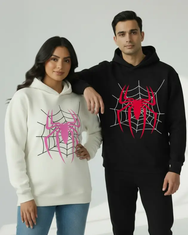 Couple wearing matching spider graphic hoodies in black and beige colors for modern streetwear fashion in Lahore Pakistan