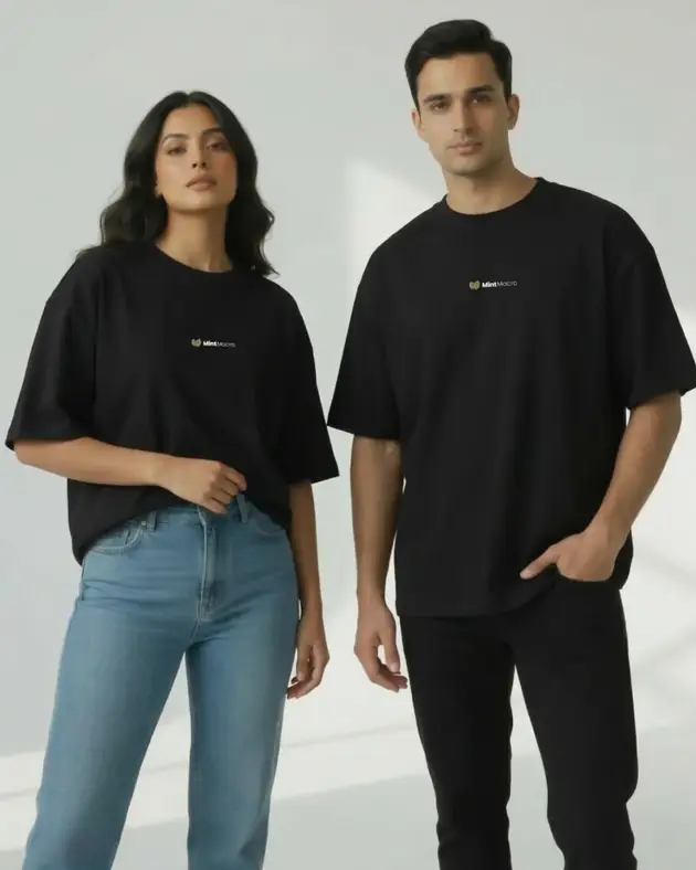 Mintmacro logo oversized black t-shirt worn by man and woman – unisex drop shoulder tee Pakistan