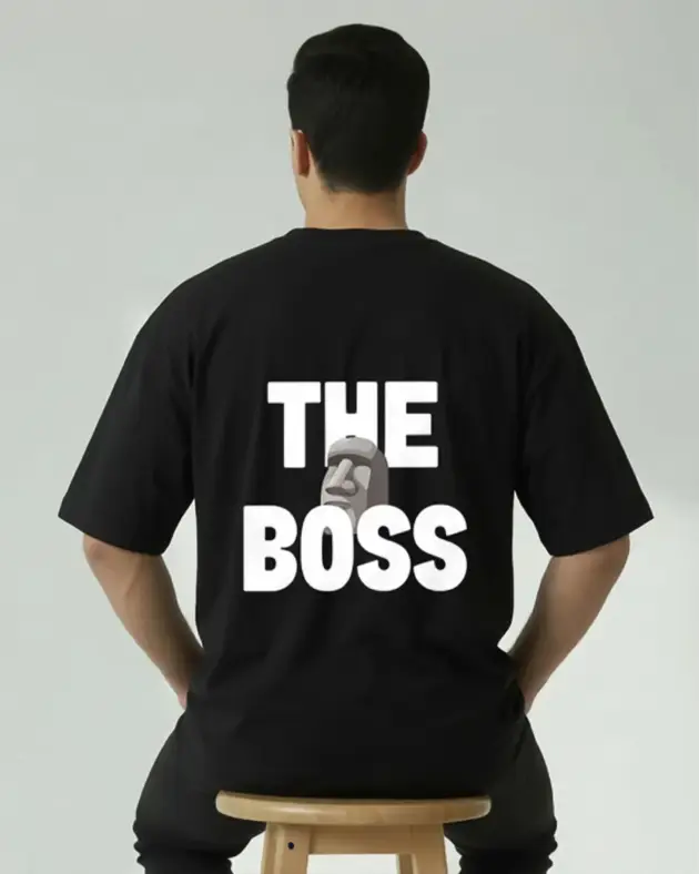 Men wearing black oversized t-shirt with bold white "The Boss" text print on the back, by Mint Macro Pakistan