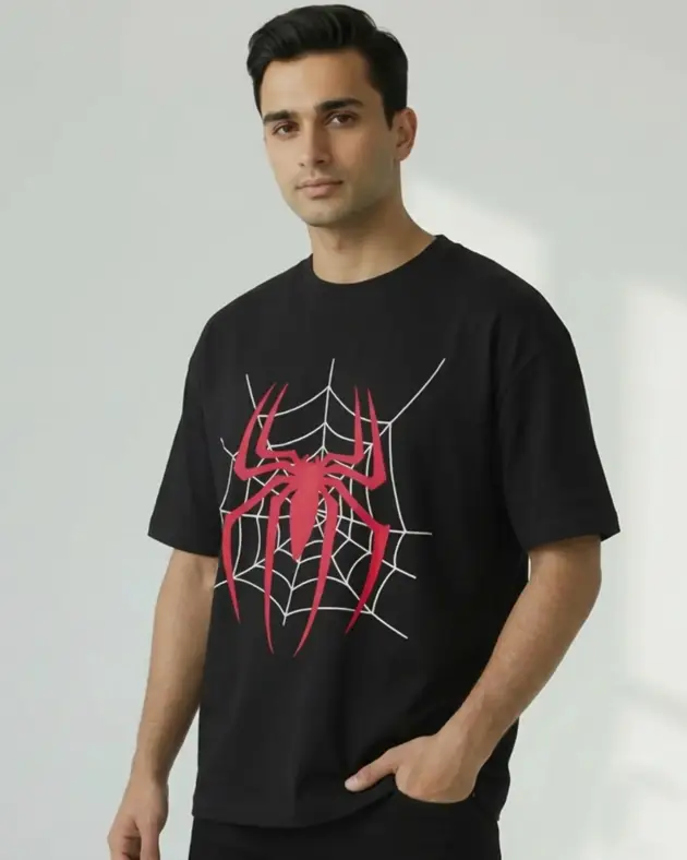 Man wearing black oversized spiderweb graphic t-shirt with bold red and white spider print, by Mint Macro Pakistan