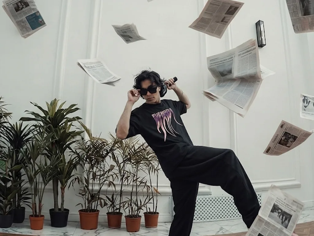 An oversized black crewneck t-shirt featuring a stylized graphic on the chest with the word "EUPHORIA" printed in a melting, liquid chrome font with shades of purple and pink trailing downward.