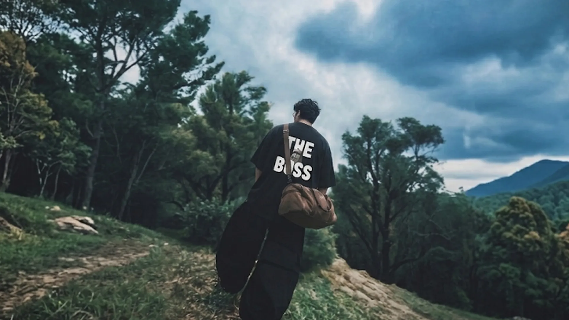 An oversized black crewneck t-shirt featuring bold white text on the back that reads "THE BOSS" with a small graphic integrated into the letter "O".